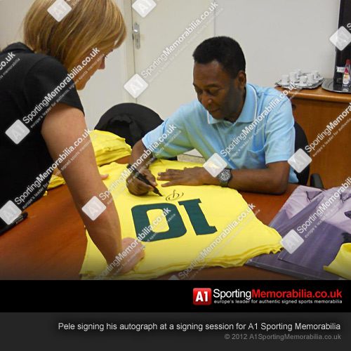 Pele signing his autograph at a signing session for A1 Sporting Memorabilia Pele signing his autograph at a signing session for A1 Sporting Memorabilia